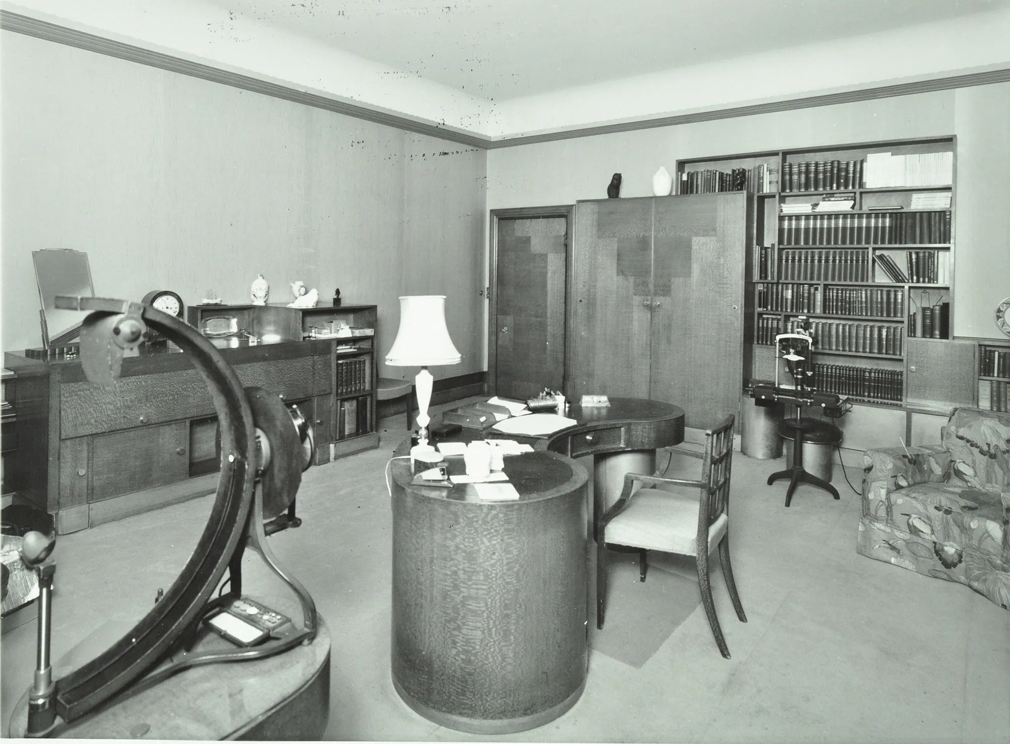 Room with curved desk and bookcase
