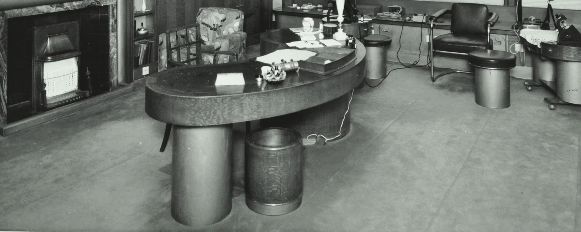 A curved desk and stools