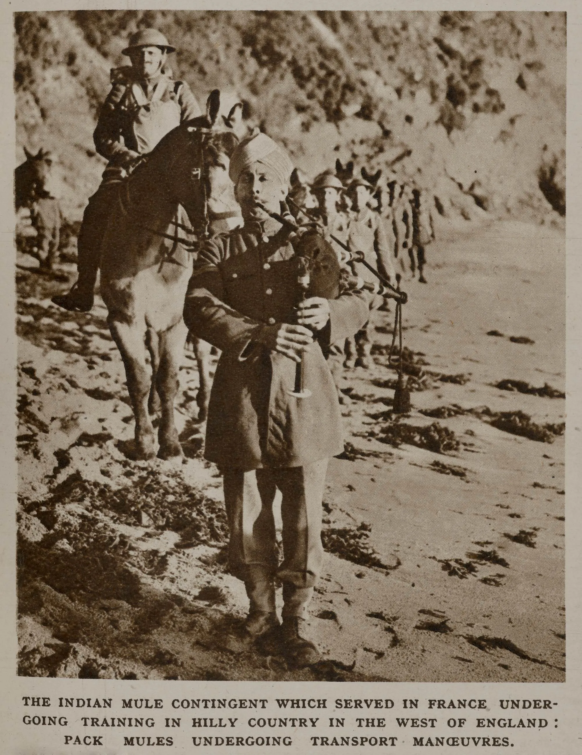 a man playing bagpipes with a troop behind in a hilly area