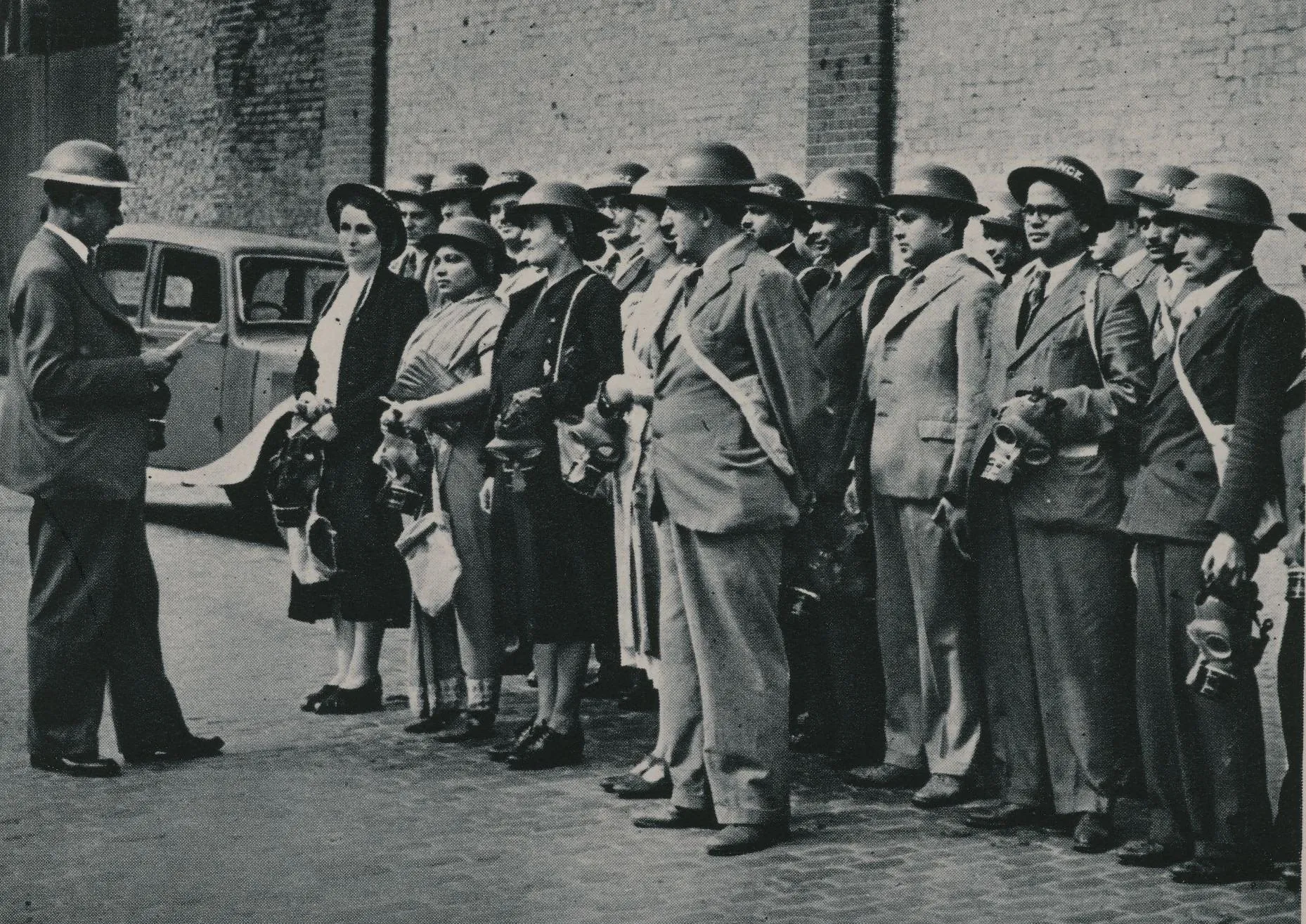 a group of people in helmets standing and facing an official