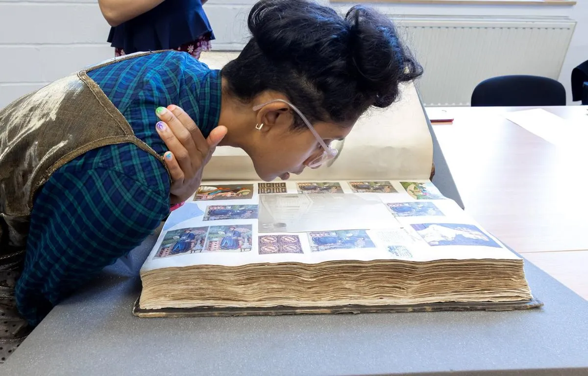 researcher-viewing-photos-from-the-archive