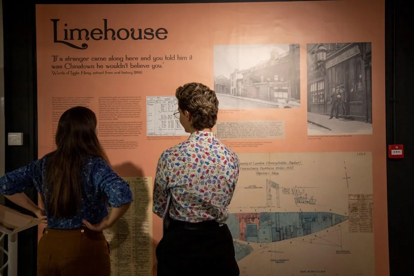 two people view the Lost Victorian City exhibition and are looking at a wall on Limehouse
