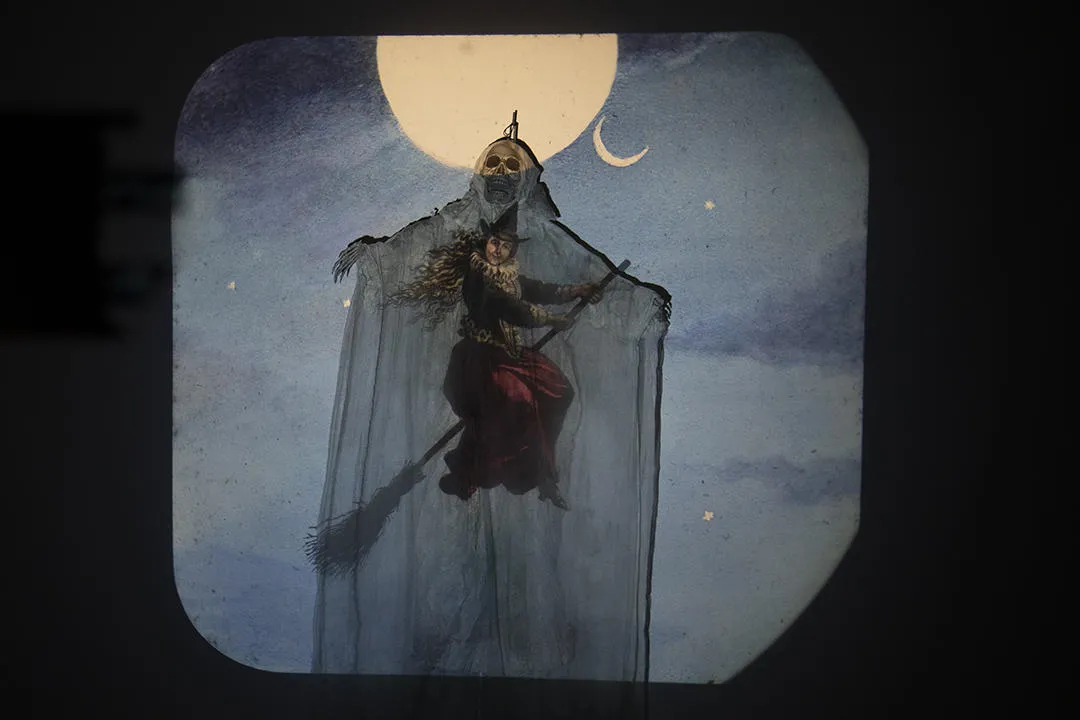 An image of a witch is projected on to a skeleton at the Magic Lantern Show at TLA, 2025.