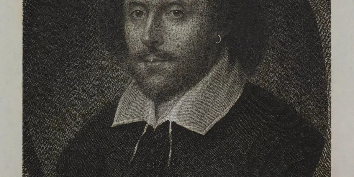 a man with a bald head and hair at the sides with facial hair and collar